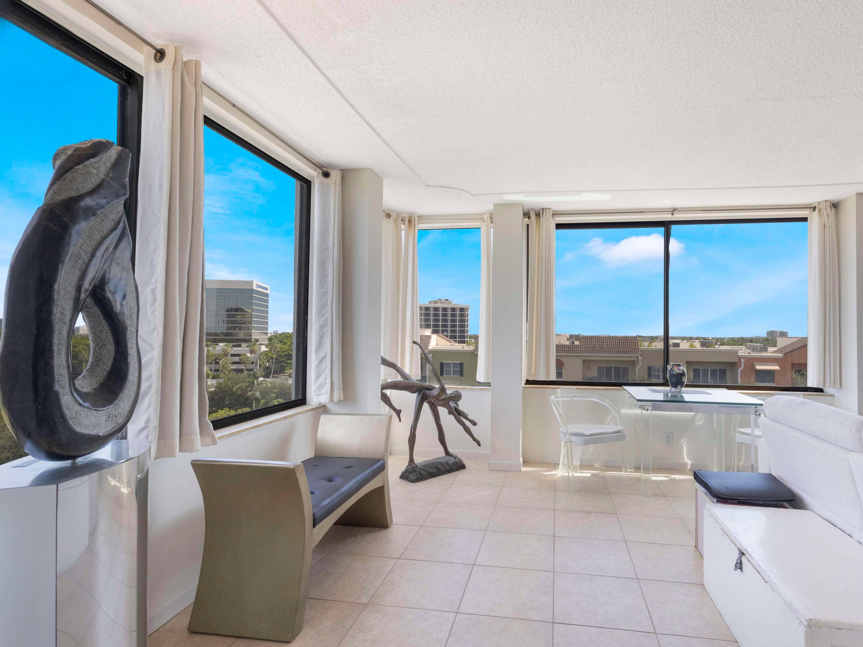Live above it all in this rare 7th floor corner condo with wrap around windows and unbeatable city convenience in the heart of West Palm Beach.