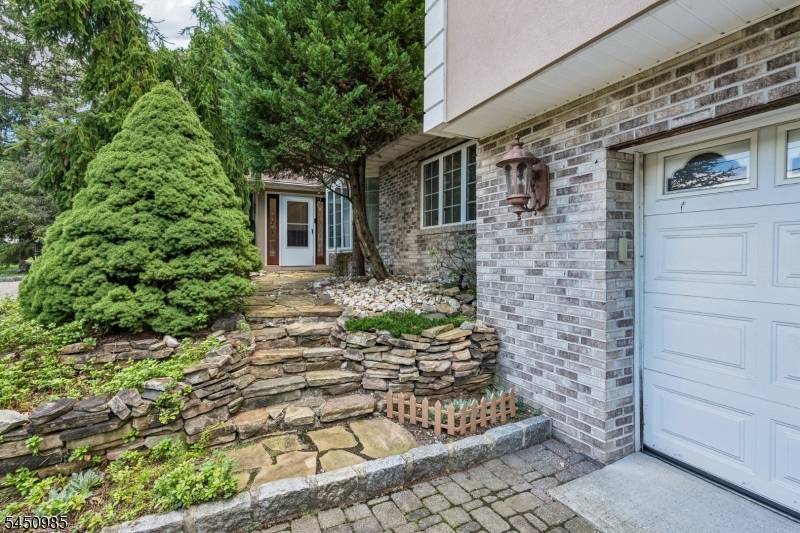 Tucked away behind a circular paver driveway and mature privacy trees, this one of a kind custom expanded ranch offers exceptional space, style, and versatility.