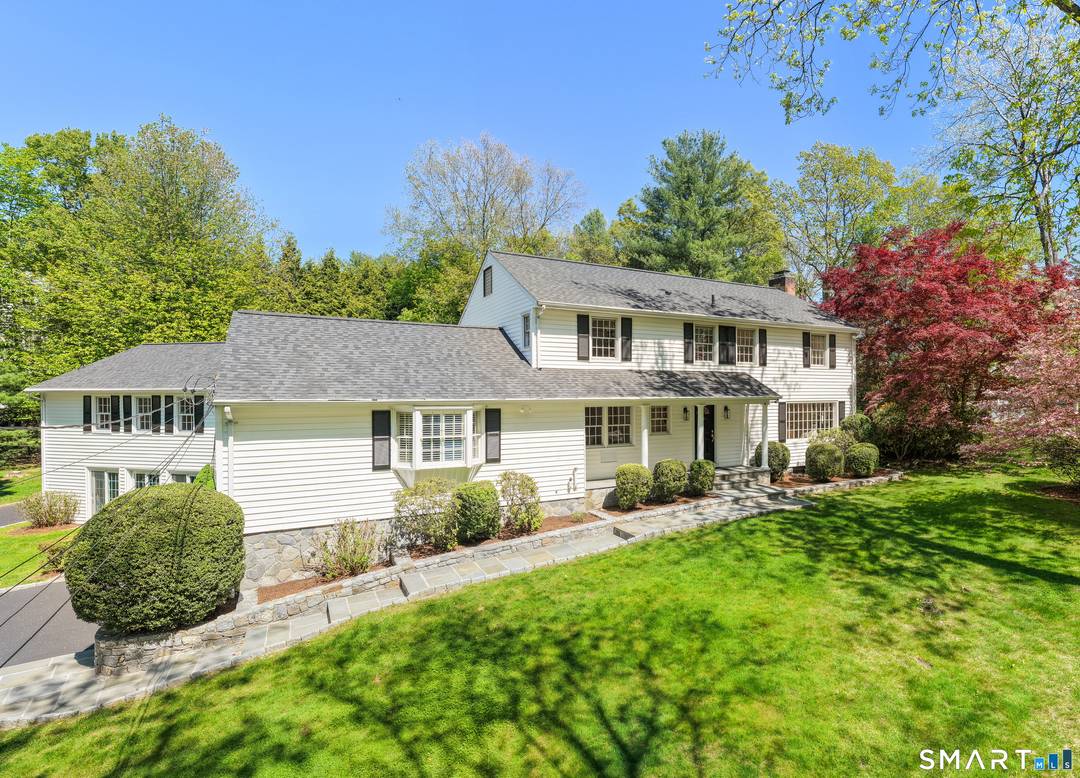 Beautifully set on a side street rise, this stately center hall Colonial has a traditional 4 bedroom, 3.