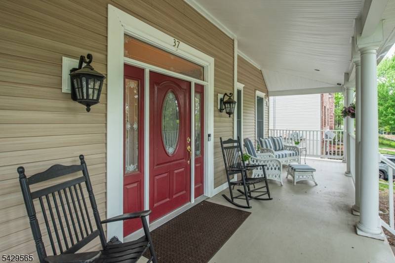 Welcome to this custom Colonial featuring a charming front porch and impressive 2 story entry foyer.