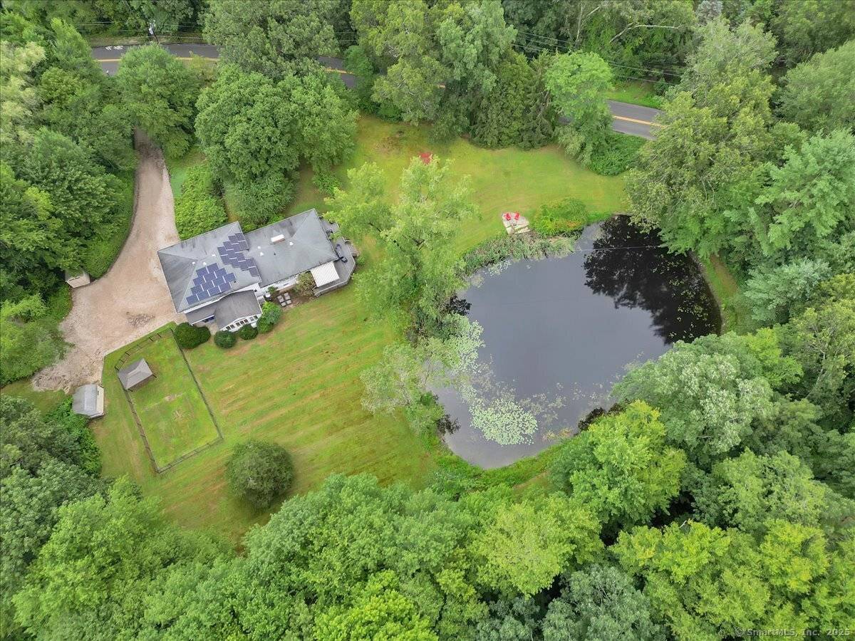 Tucked away in a serene, private pondside setting, yet just minutes away from shopping and schools, this beautifully preserved mid century home offers a unique blend of timeless design and ...