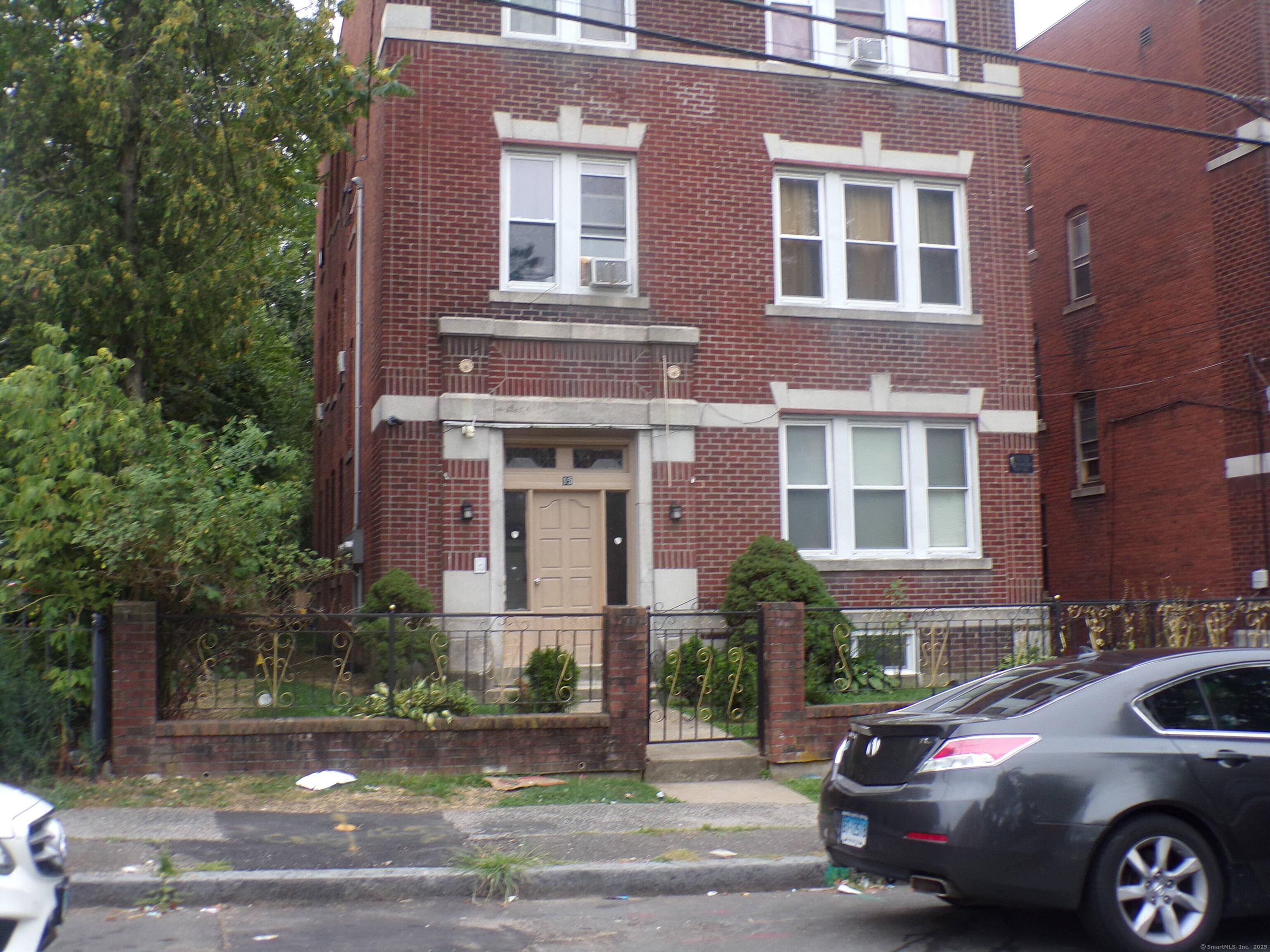 Well kept three family with brick exterior and two large car garages.