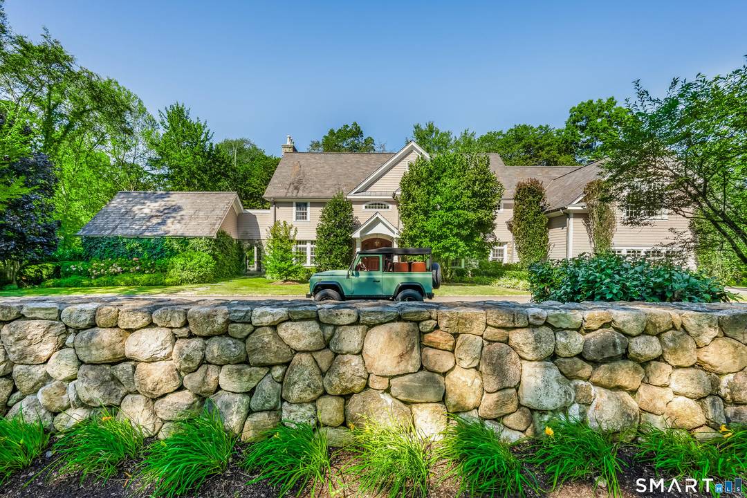 Welcome to 473 Hollow Tree Ridge Road in Darien a custom built, stone and shingle Colonial set on 1.