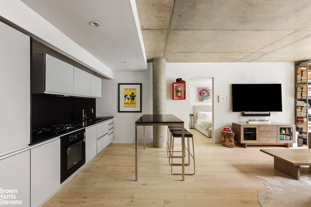 Industrially inspired, Unit 204 is a loft like two bedroom two bathroom condominium featuring a floor to ceiling glass window wall.
