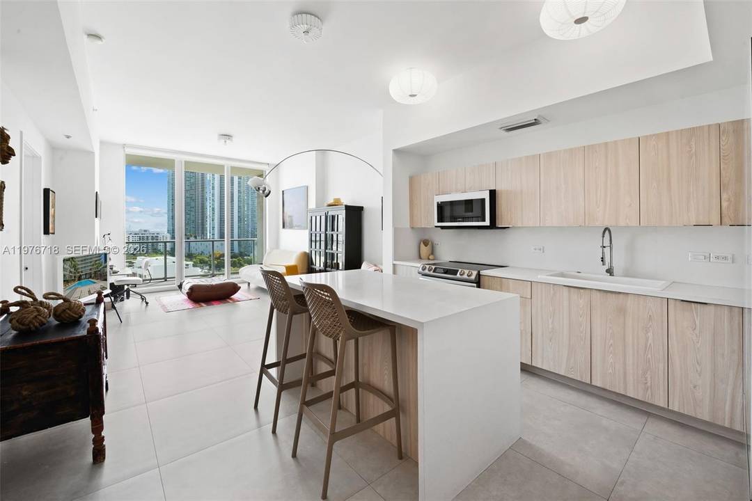 This is the kind of home that arrives completely renovated, thoughtfully considered, and positioned in one of Midtown Miami's most desirable buildings with views of Biscayne Bay and the skyline ...