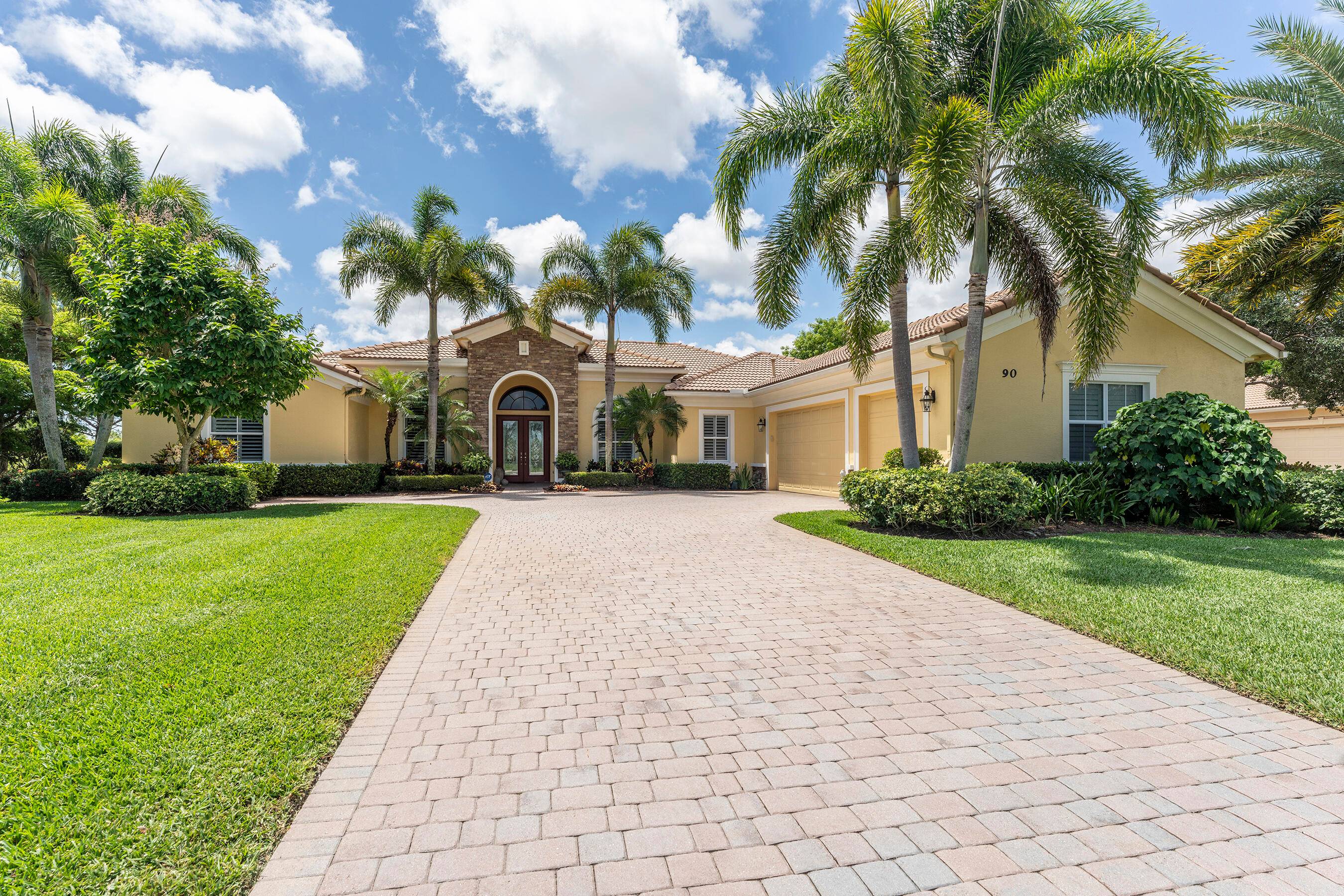 Welcome to 90 SE Ethan Terrace, a stunning 3 bedroom, 4 bathroom plus office residence in the exclusive Stuart community of Tres Belle overlooking a beautiful lake.