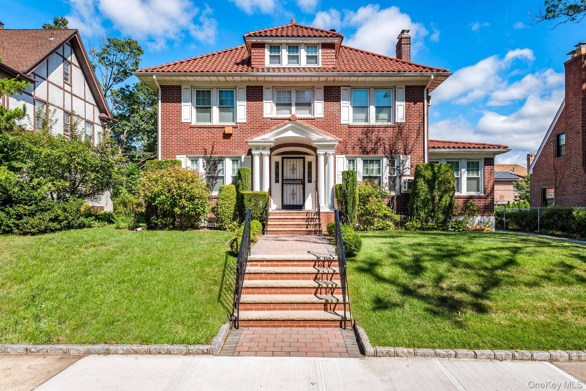 Five Star Classic Brick Center Hall Colonial This timeless, all brick center hall colonial, crowned with a distinctive clay tile roof, showcases enduring craftsmanship combined with thoughtful modern updates.