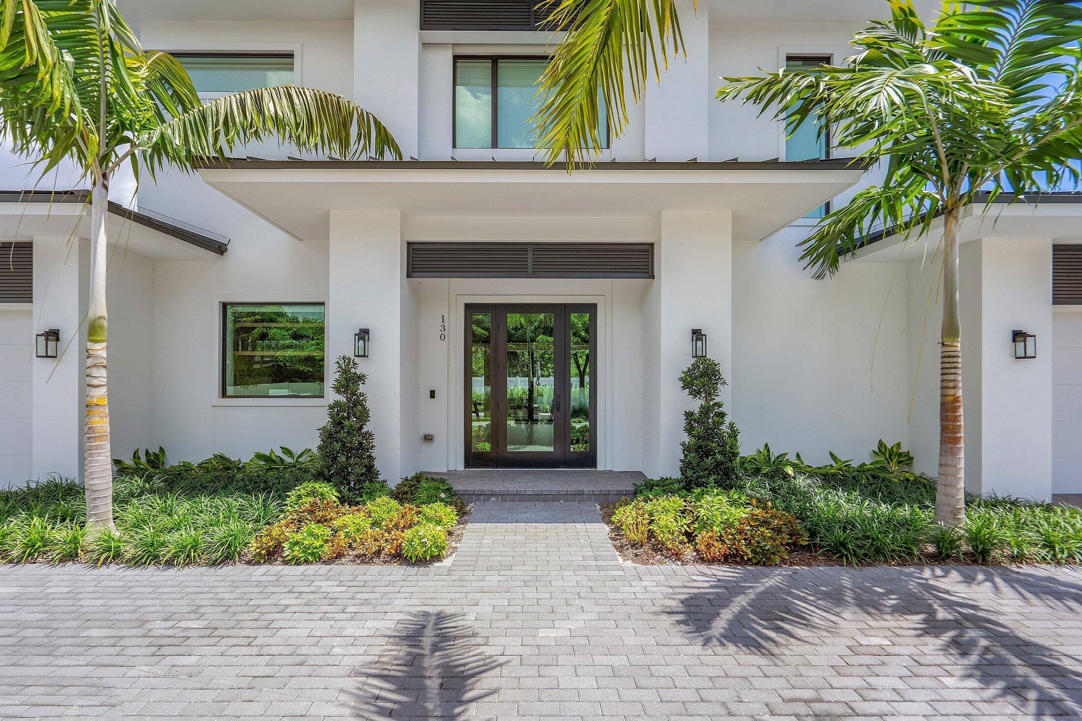 Welcome to 130 Pineapple Road, a coastal modern retreat on a quiet, no through street in the heart of Delray Beach.