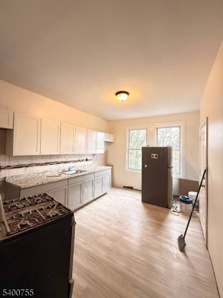 Charming 2 story two family home in the desirable Bayview Ave area of Jersey City.