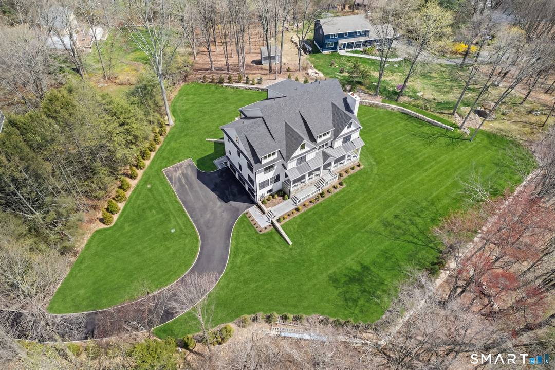 Welcome to 150 Wildwood Road, an exceptional new construction residence that perfectly blends timeless colonial architecture with modern sophistication.