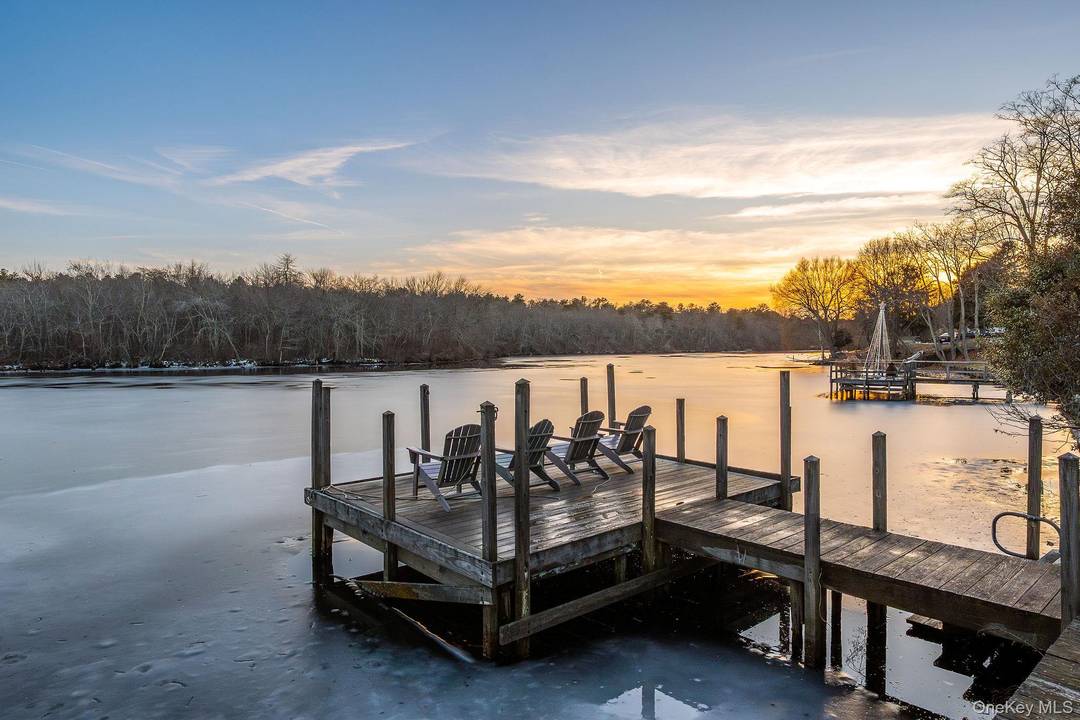 Updated waterfront cottage with dock on the Peconic River, ideally located on West Main Street in Riverhead and offering a strong rental history.
