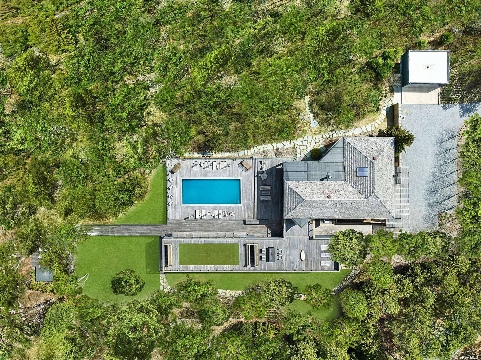 Above the Dunes with Panoramic Views in Amagansett perched above the Amagansett Dunes, on over 5 acres of luscious land, sits this magnificent modern masterpiece with incredible panoramic oceanviews.