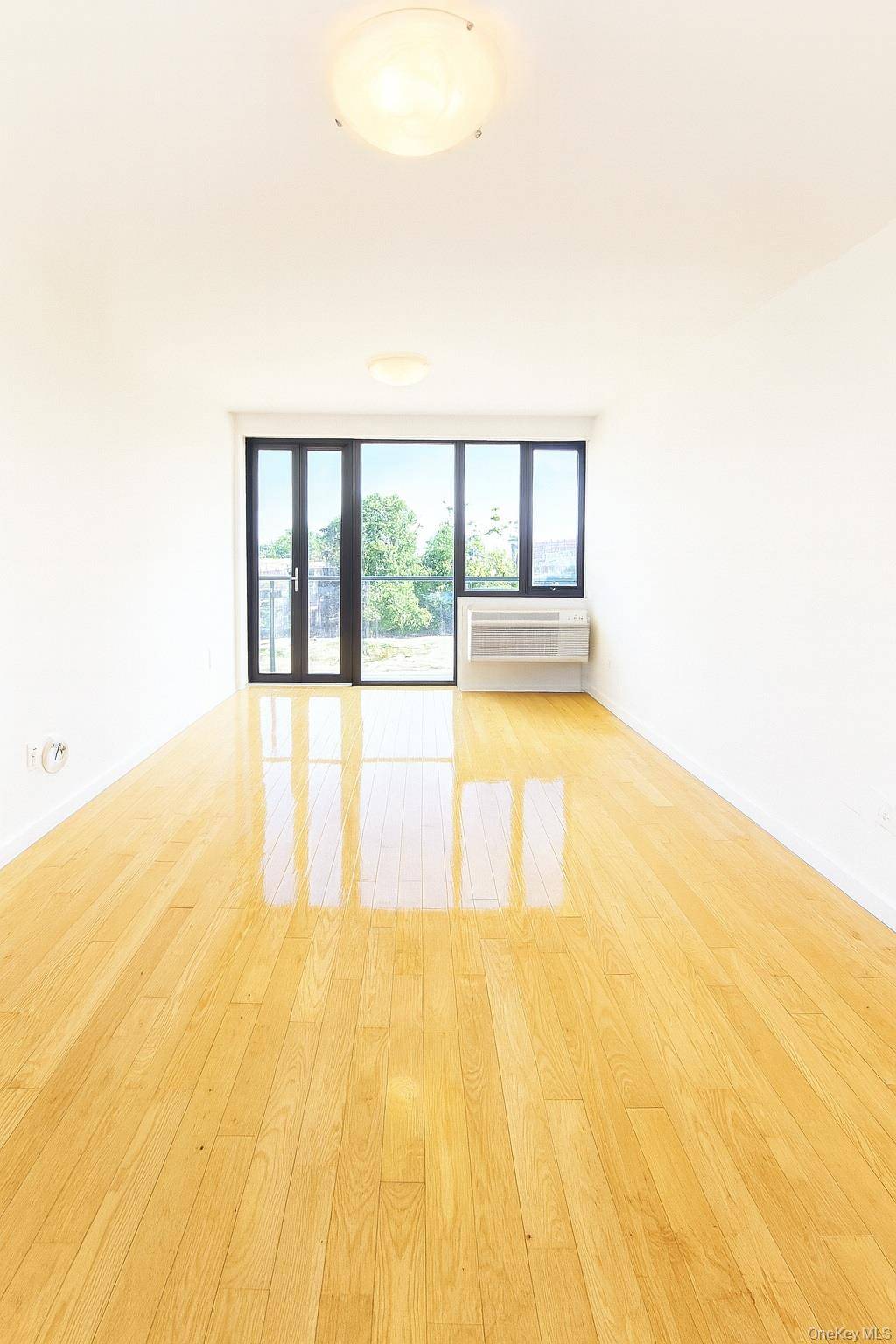 Modern 2 bedroom, 2 bath condo in an elevator building, featuring a separate kitchen with stainless steel appliances, hardwood floors, and an in unit washer and dryer.