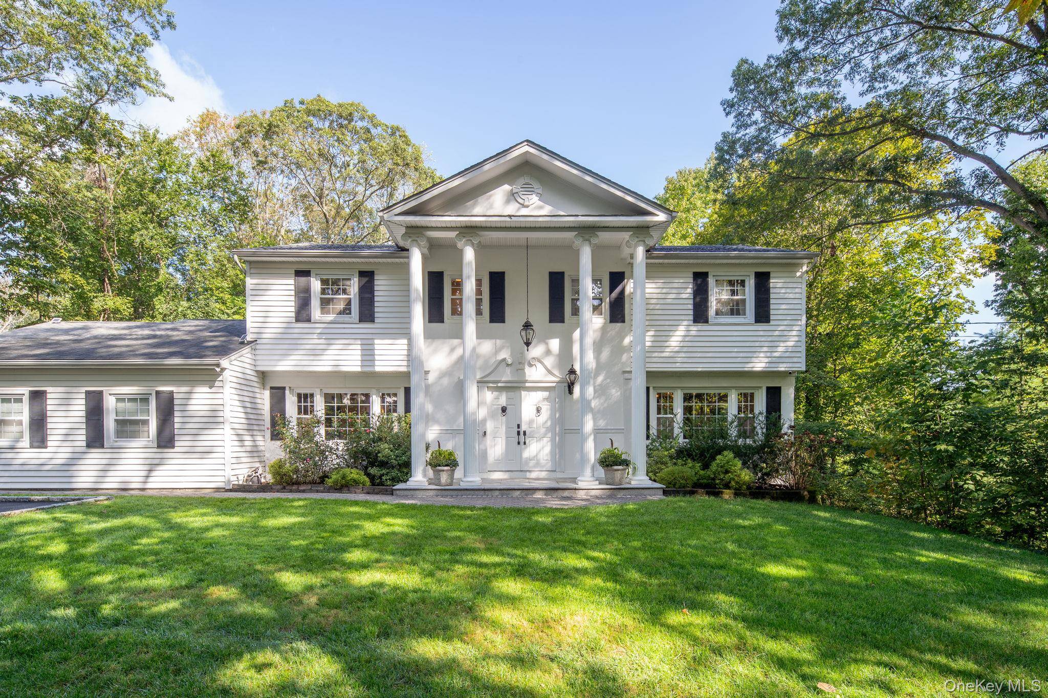 Impeccably updated and truly move in ready, this elegant 4 bedroom, 3 bath Center Hall Colonial sits on a full acre in the heart of Dix Hills.