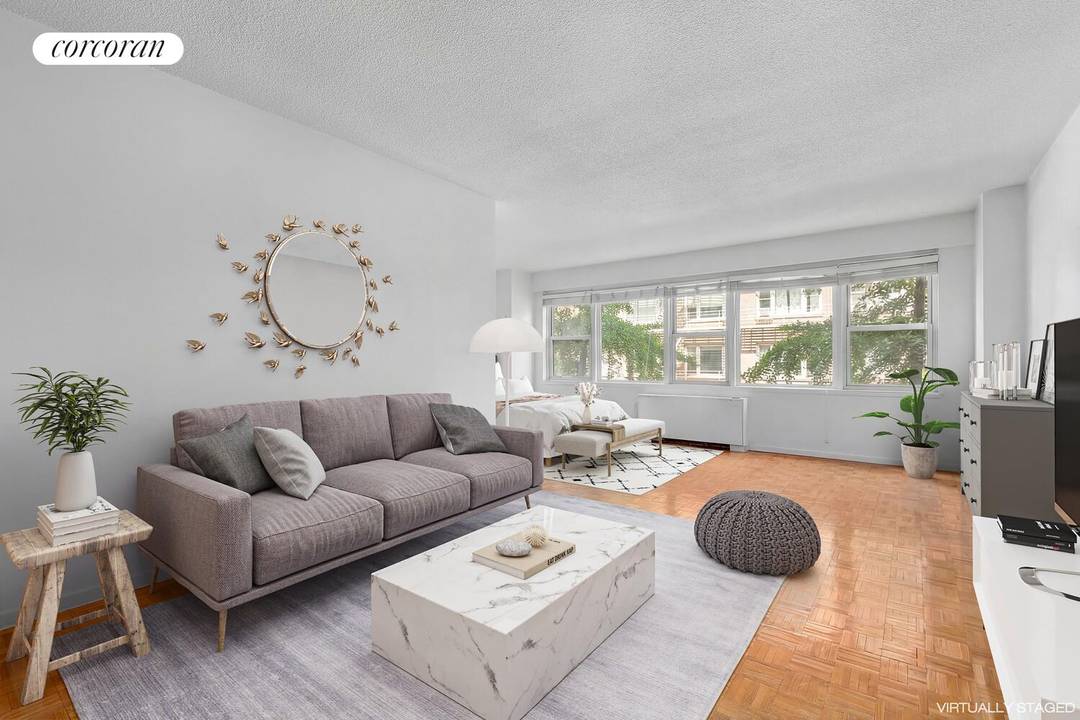 This large alcove studio is faces north along tree lined E 81st Street and has a wall of windows with great light.