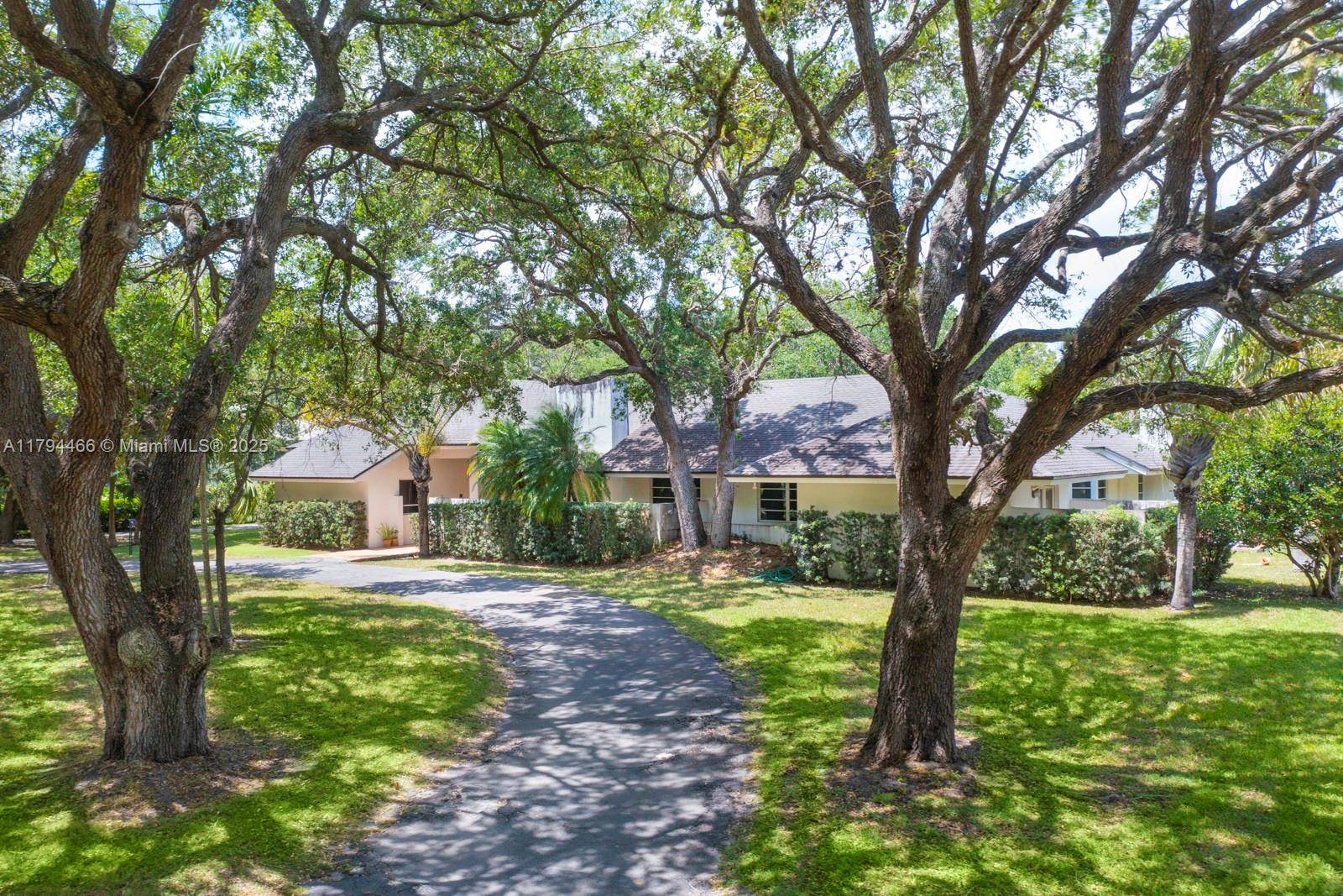 Prime North Pinecest oak laden acre home on one of the most desired and private streets in the best area of Pinecrest.