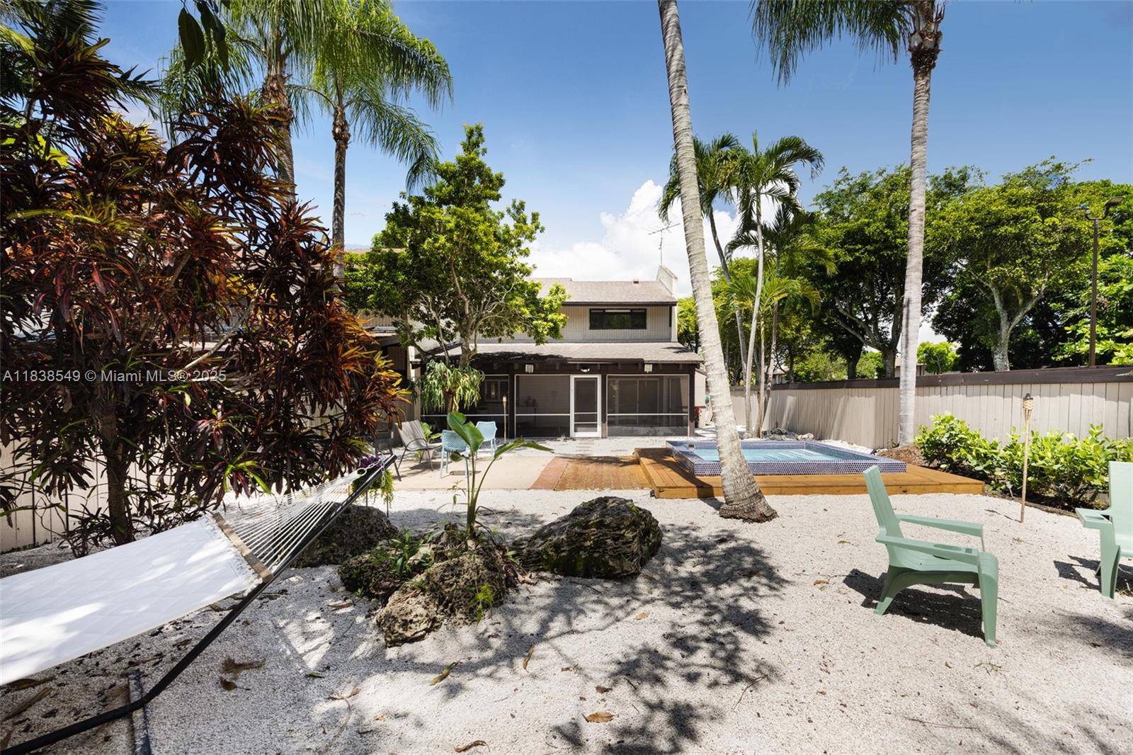 A private Key West style retreat nestled behind lush foliage in The Falls Townhouses.