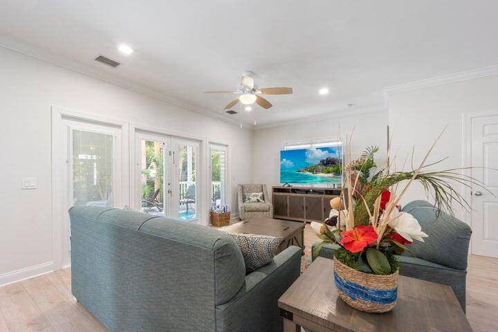 Indulge in the luxury of this prestigious single family home, complete with your own pool, nestled within the gates of the Sanctuary at Hawks Cay.