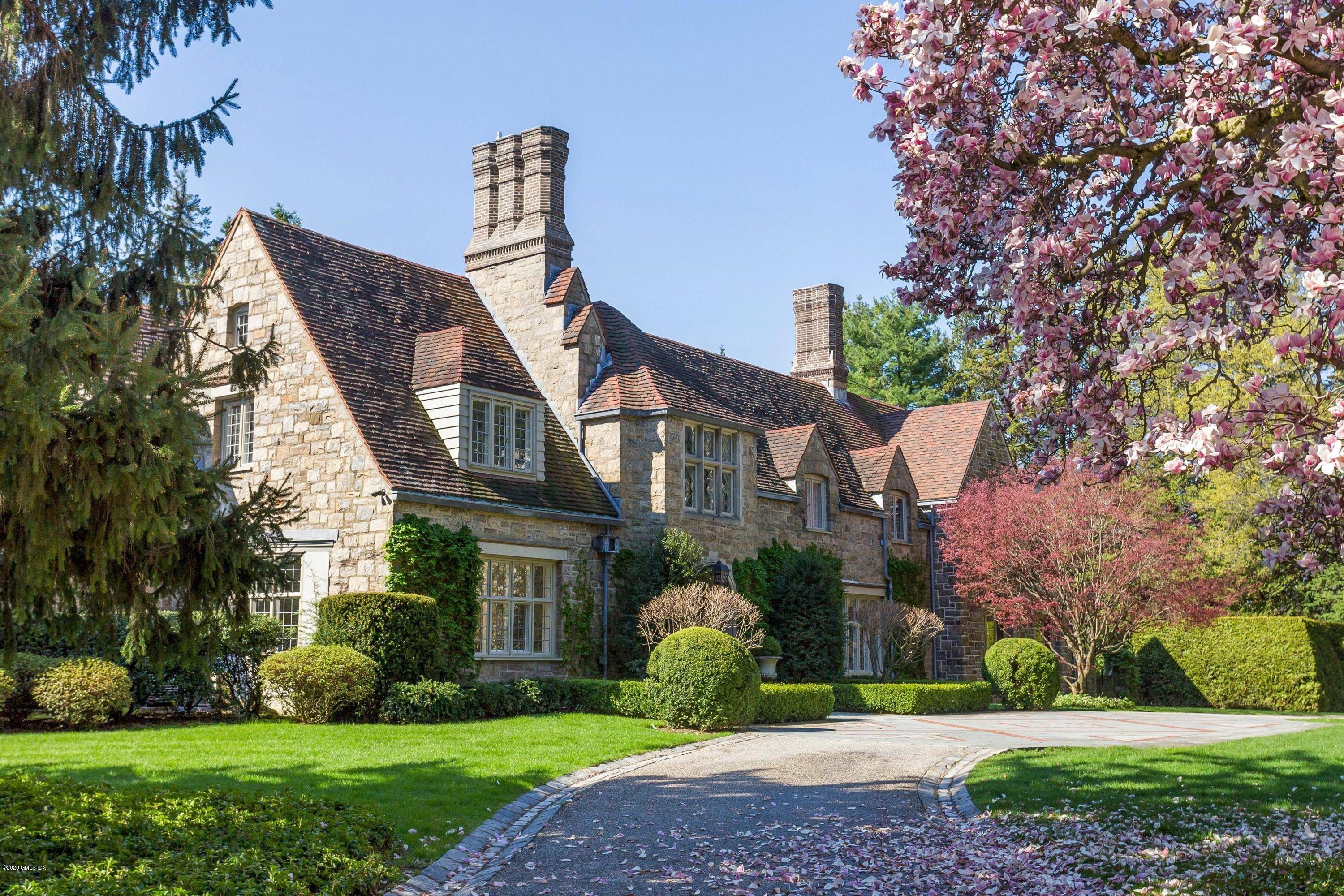 Exceptional Belle Haven peninsula stone English Manor style completely renovated and expanded in 2017 with outstanding quality finishes throughout.