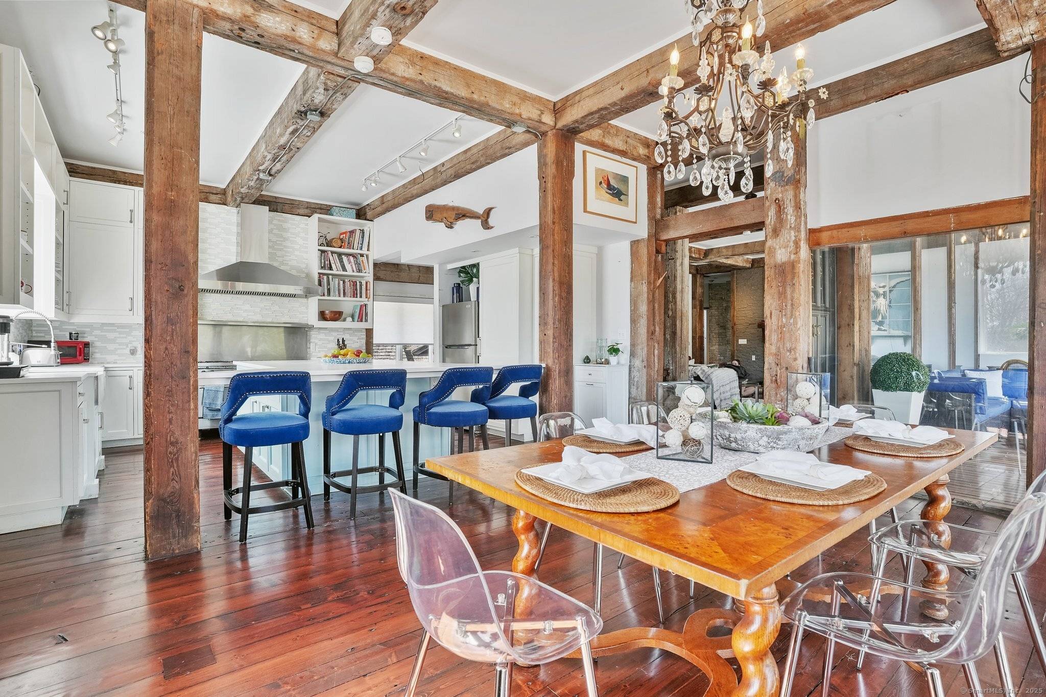 This extraordinary property stands as a testament to thoughtful preservation and modern comfort with soaring 11 foot ceilings and walls of glass that flood the interior with natural light.