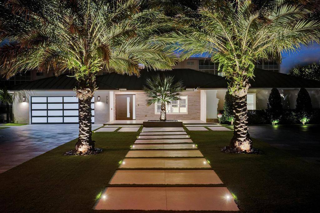 Situated on a private peninsula in the prestigious Lake Rogers neighborhood, this refined waterfront home has all the bells whistles.