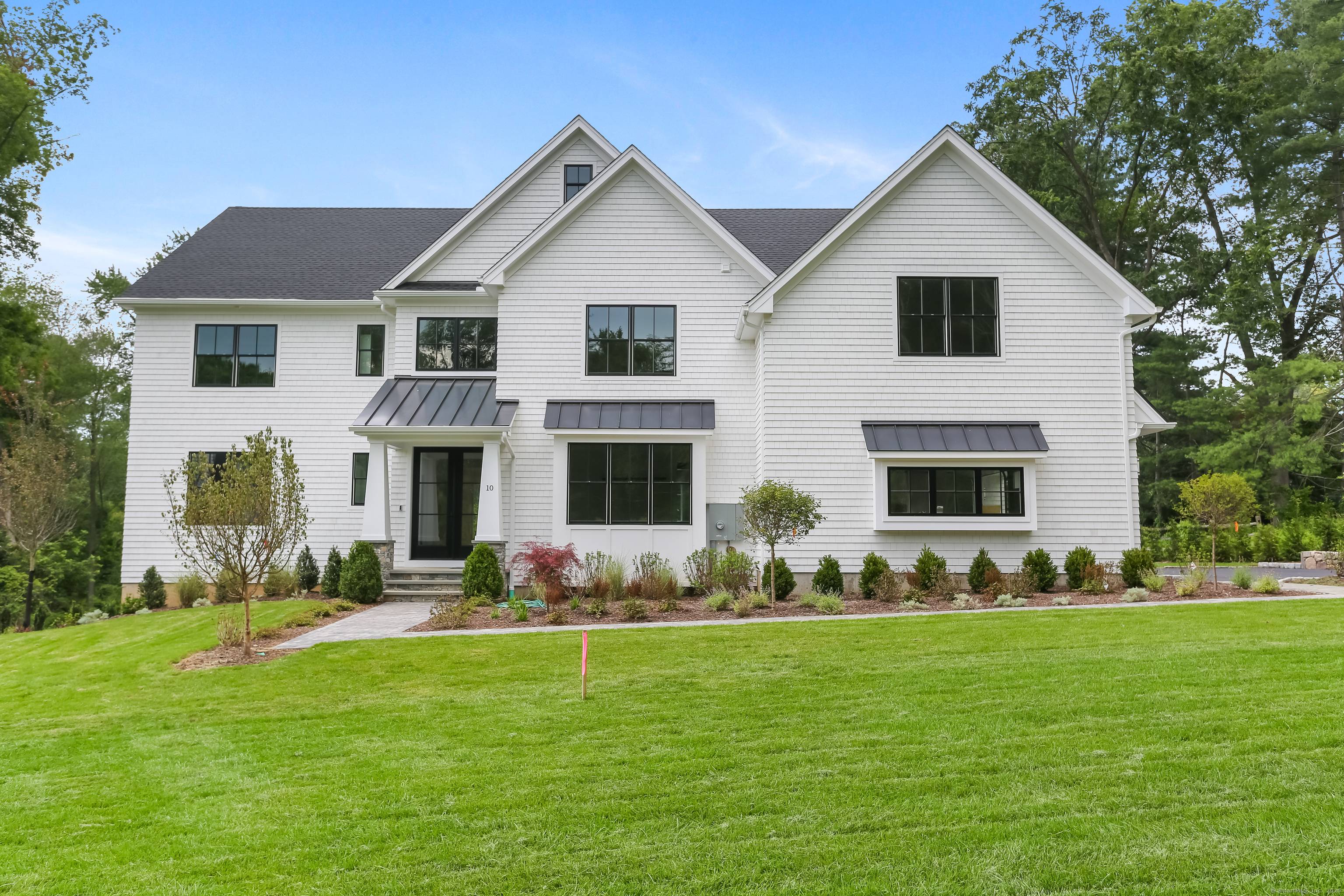 This is the second of 2 custom homes in final stages of completion, beautifully sited at the end of a private lane in the heart of Greens Farms.