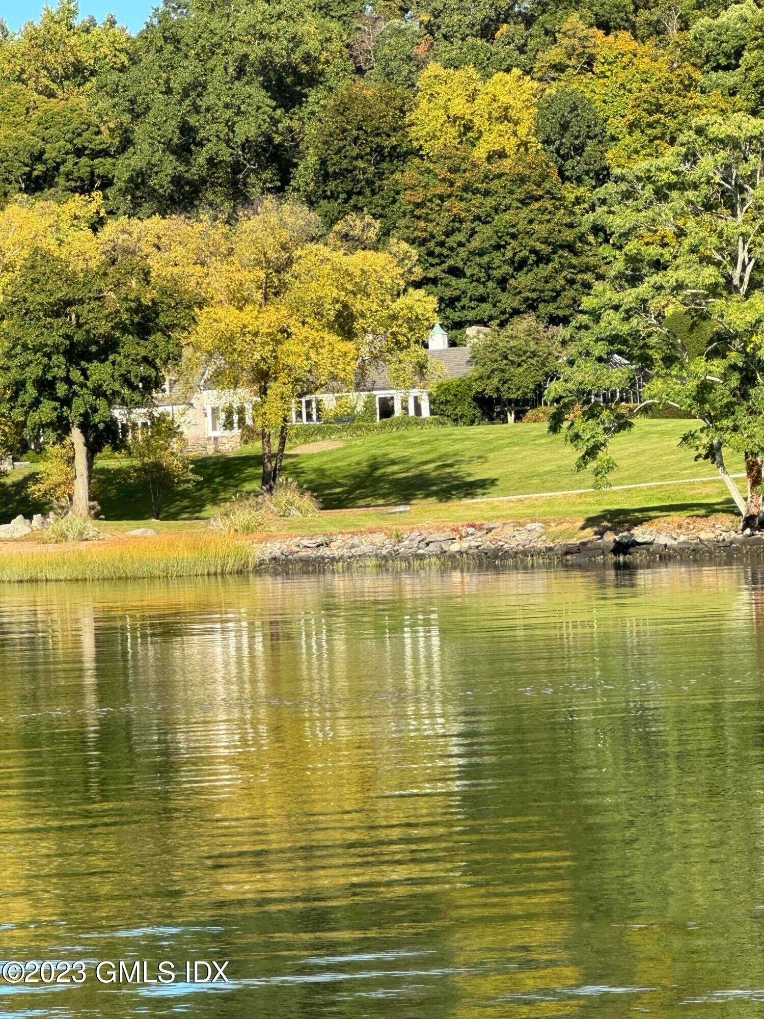 Rare opportunity and prime location within the gated Quarry Farm in Belle Haven, the breathtaking water views, and ample acreage, this estate offers a serene and luxurious oasis.
