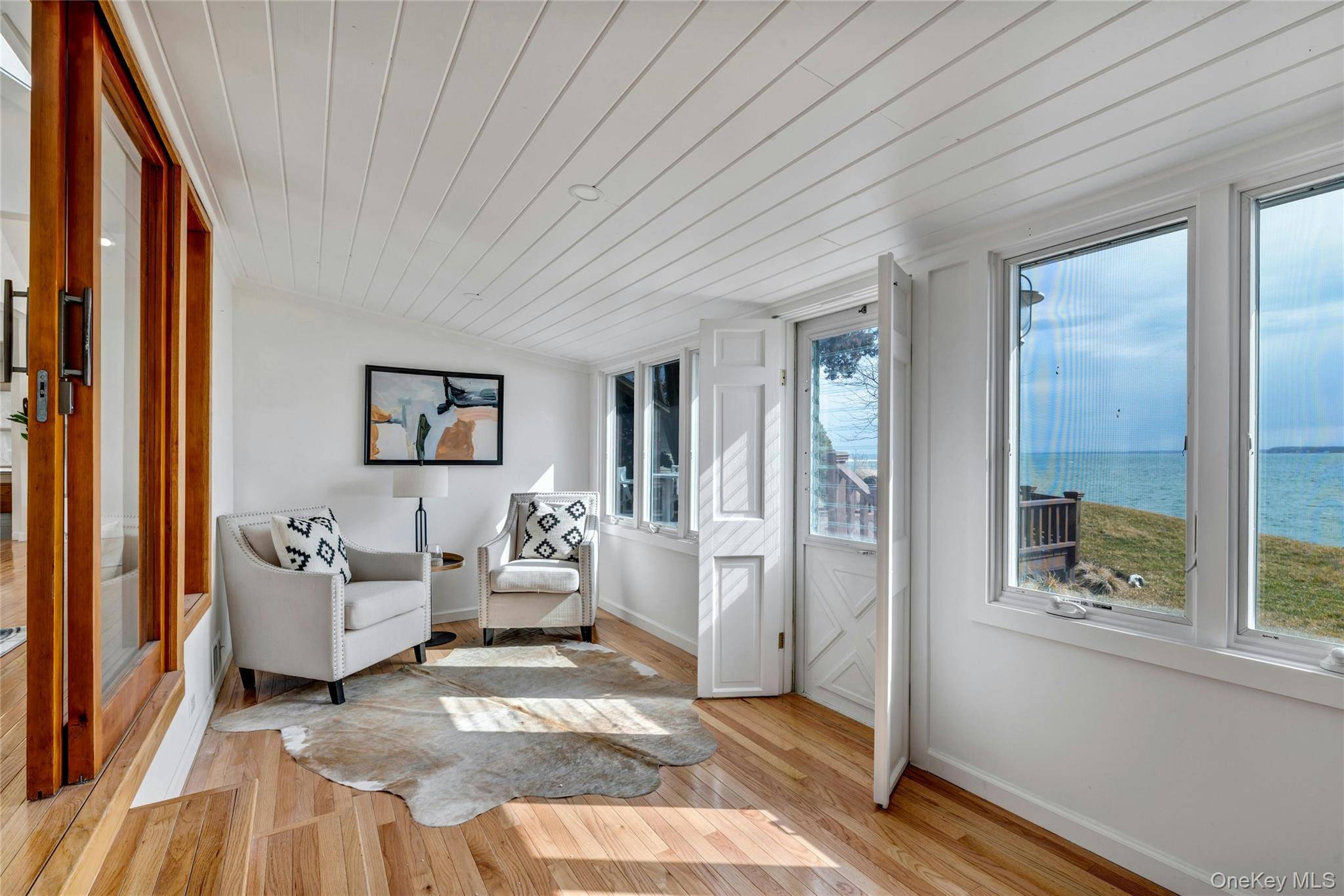 NORTH FORK DIRECT BAY FRONT GEM ON QUIET STREET WITH HIGH ELEVATION AND 115' FRONTAGE Introducing a captivating waterfront property on the Peconic Bay in Jamesport boasting a large lot ...