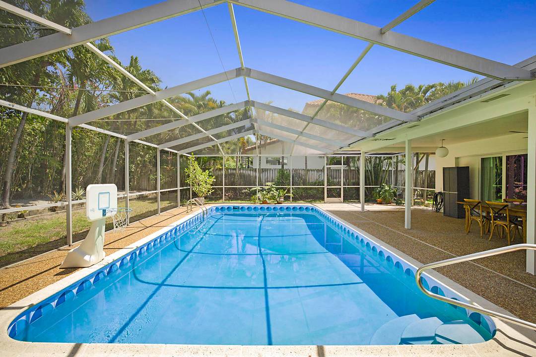 Experience East Boca living at its finest in this beautifully renovated 4 bedroom, 3 bathroom Mid Century Modern home with a sparkling private pool.