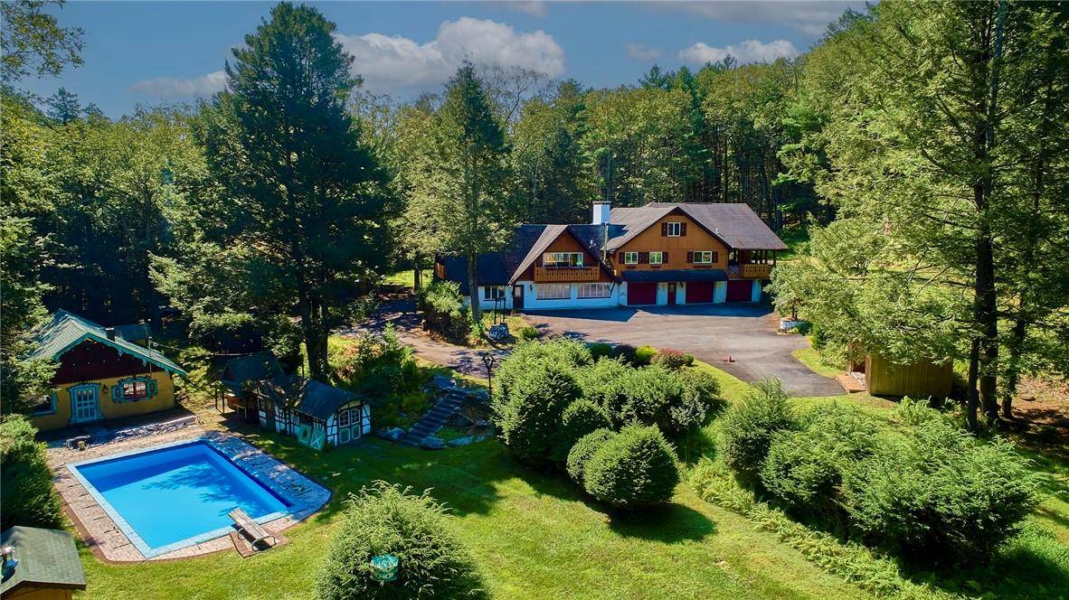 STORYBOOK COMPOUND TUCKED AWAY IN A 2000 ACRE PRIVATE CLUB Welcome to this beautiful chalet that's privately set on 13.