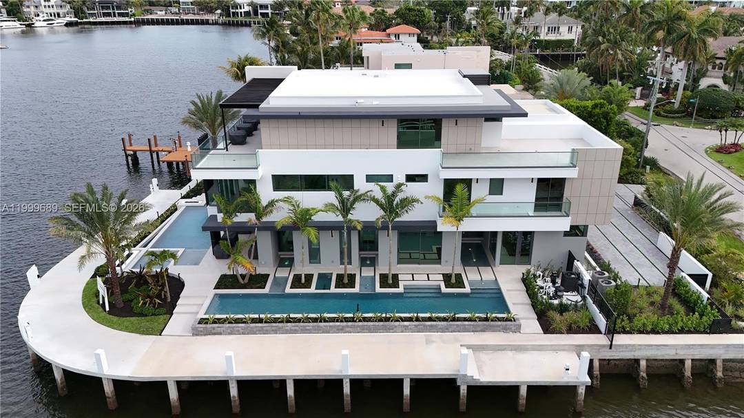 Set on a coveted point lot within the exclusive Harbor Beach enclave, this newly constructed modern estate represents a premium tier of waterfront luxury.