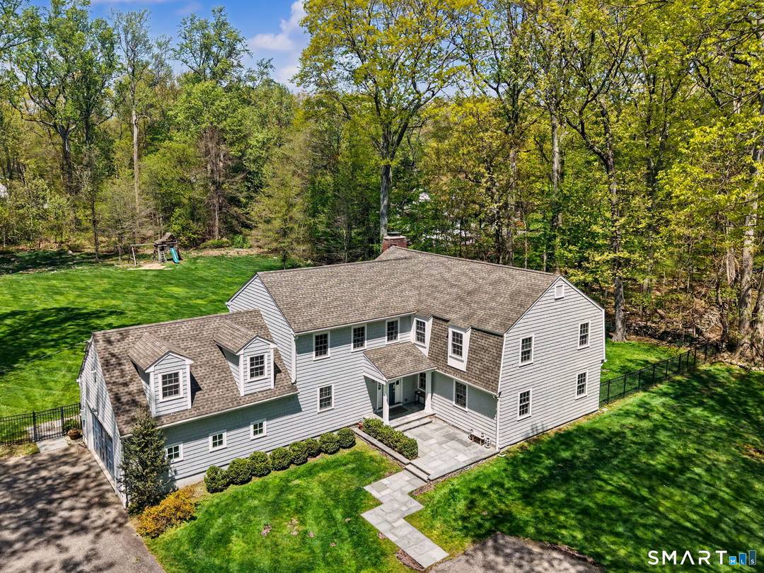 Welcome to 4 Cardinal Lane a beautifully expanded and thoughtfully updated home set on two private, level acres in one of Westport's most desirable cul de sac neighborhoods.
