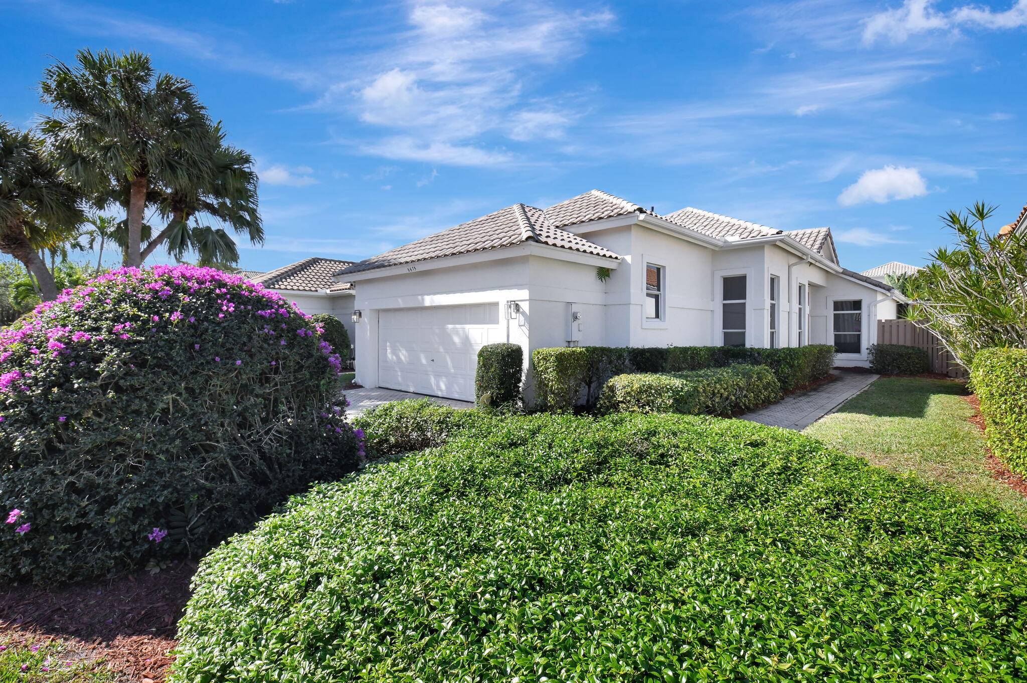 Discover the epitome of modern living in the prestigious Village of the Banyans at Broken Sound Country Club.