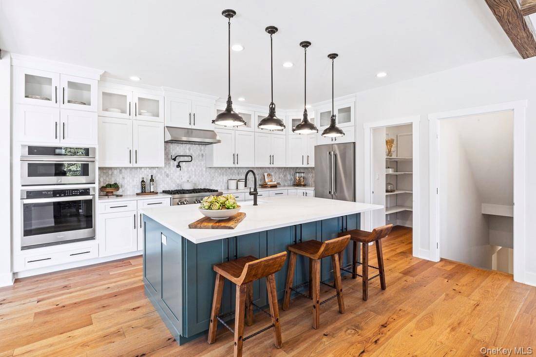 Immediate Move in ! Complementing the well designed kitchen is an immense center island with a breakfast bar as well as plenty of counter and cabinet space, and a sizable ...