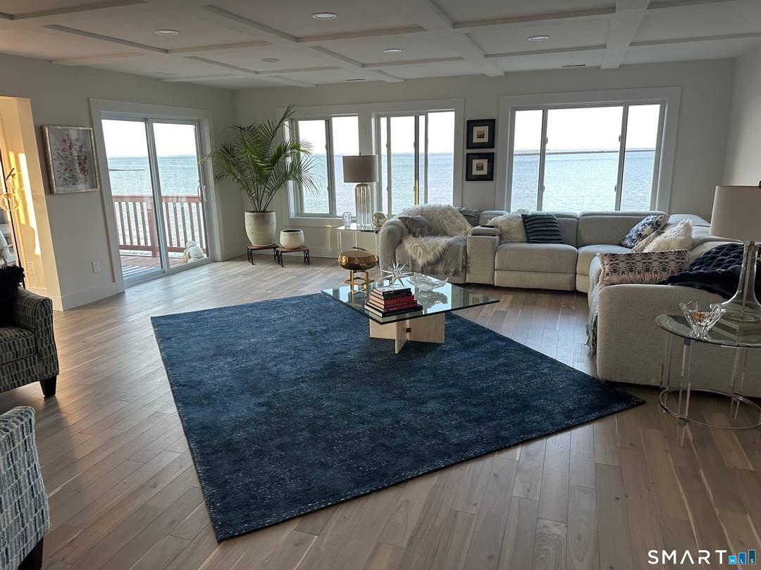 Experience the pinnacle of Connecticut shoreline luxury in this designer curated waterfront townhouse, perfectly positioned in East Haven's most coveted gated community.