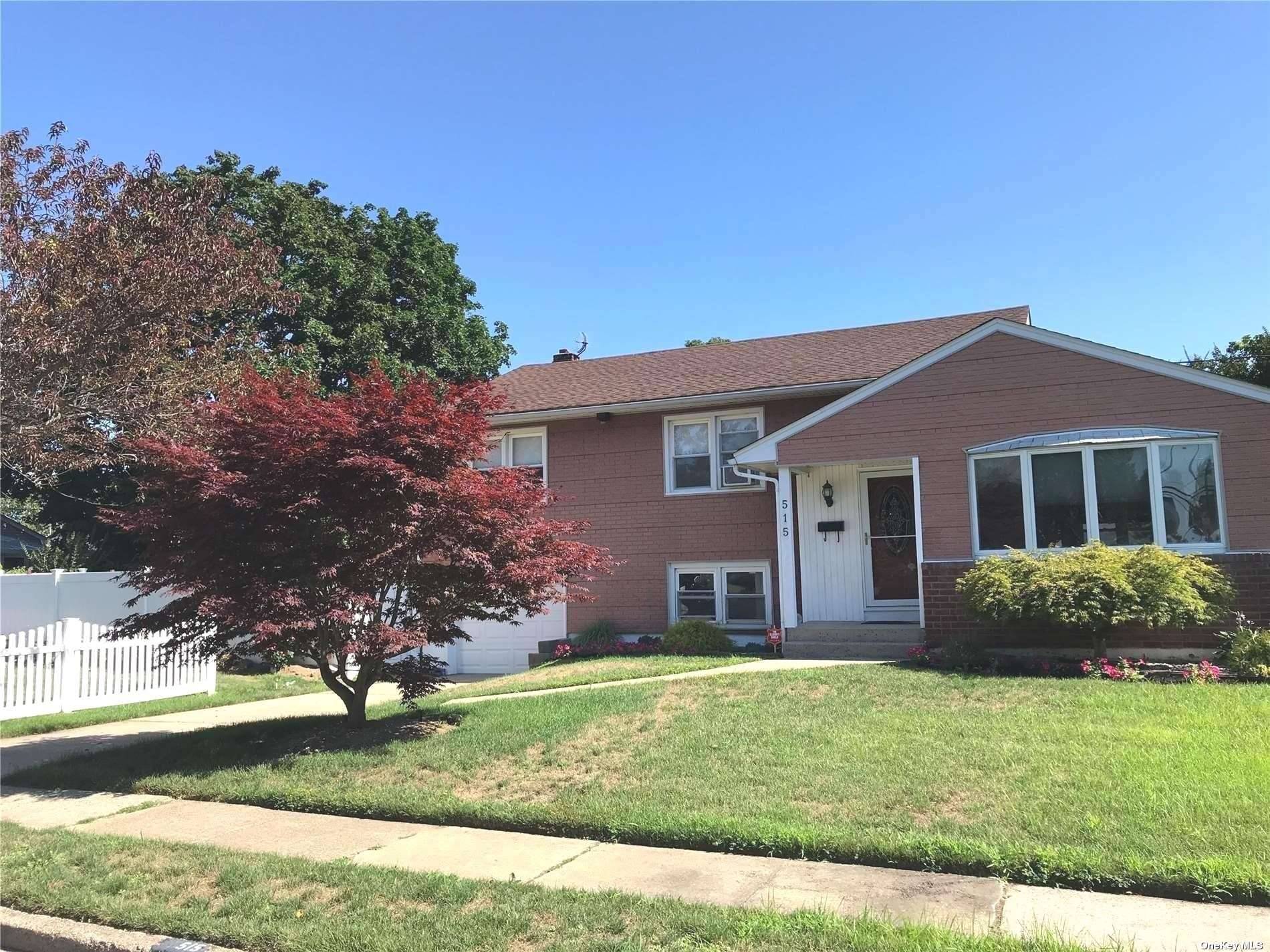 Beautiful Split Level Home which boasts updated eat in kitchen, living room, and formal dining room with hardwood floors throughout.