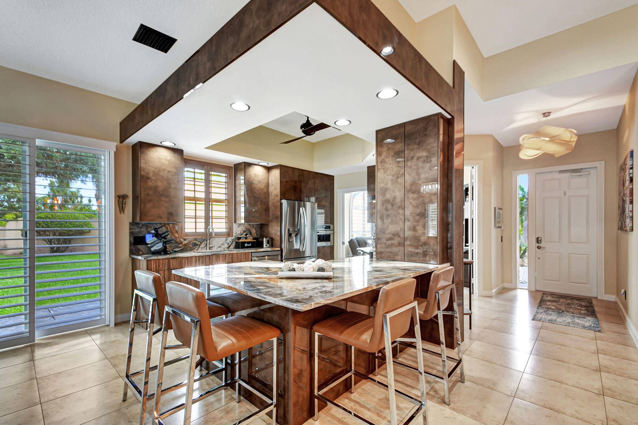 Experience this singular artistically created highly customized residence at VillageWalk, a coveted Wellington, Florida DiVosta development.