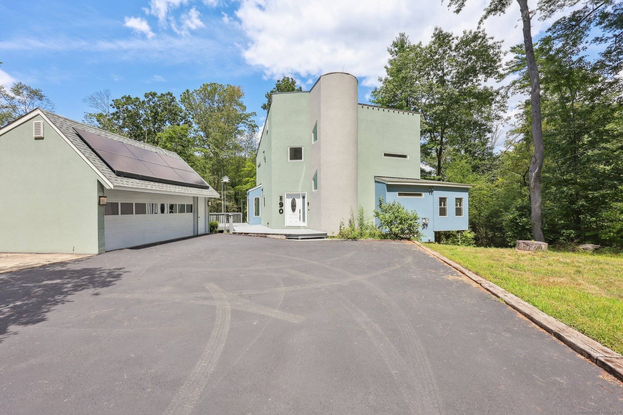 Incredible contemporary home close to the coast, directly situated on Van Wie Pond with access to Branford Land Trust.