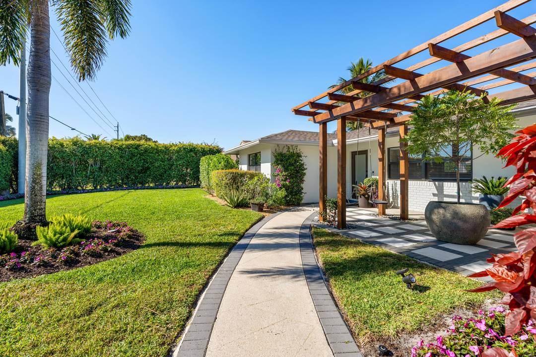 This remodeled ranch in Boynton Beach's Lake Eden neighborhood offers a permanent vacation lifestyle along serene Lake Ida.