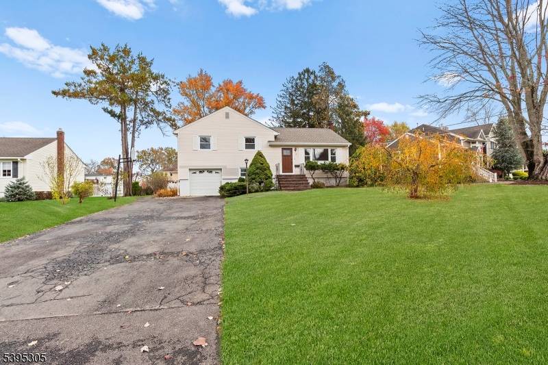 Welcome to this beautifully maintained split level residence, perfectly situated on one of the most picturesque streets in center of East Hanover.