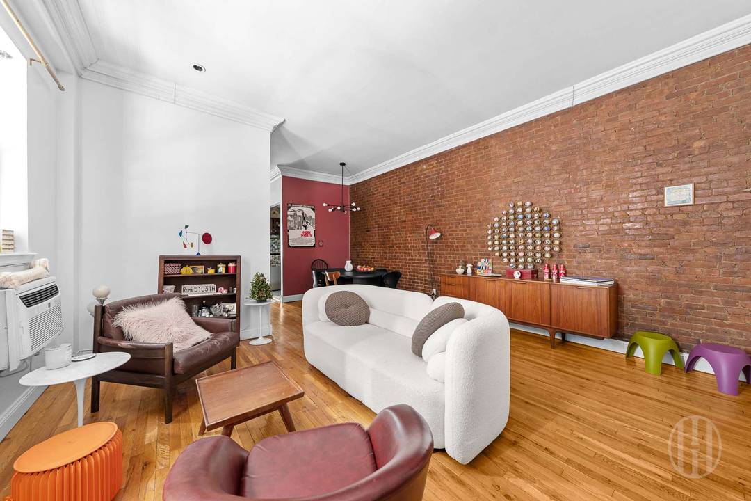 This charming two bedroom, one bathroom residence perfectly blends historic industrial character with modern style, featuring a large open living and dining area defined by a stunning floor to ceiling ...