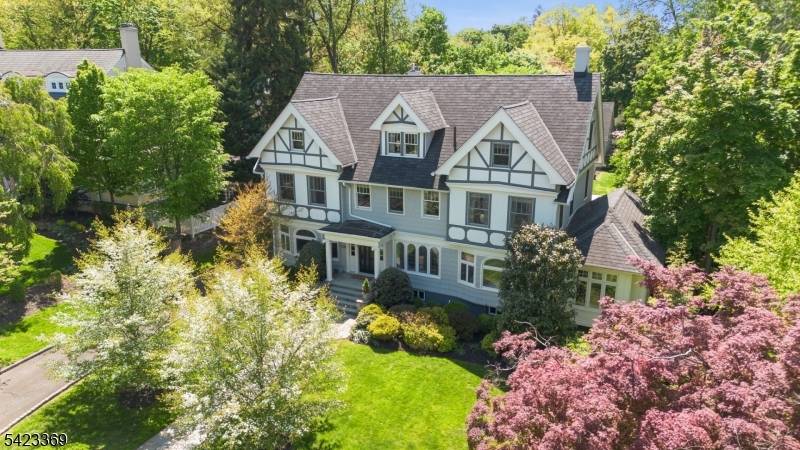 Exquisite Tudor Revival masterpiece situated on a rare.
