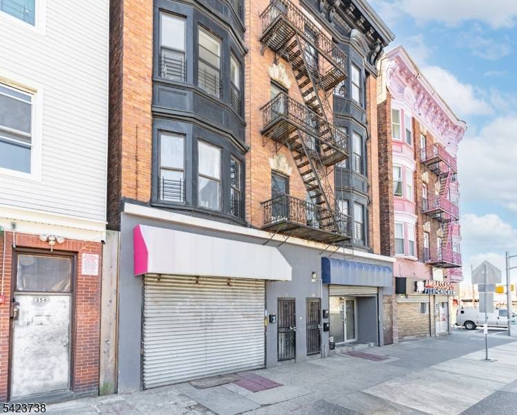 Income producing mixed use asset featuring 6 residential units and 2 street level retail spaces on a high traffic corridor.