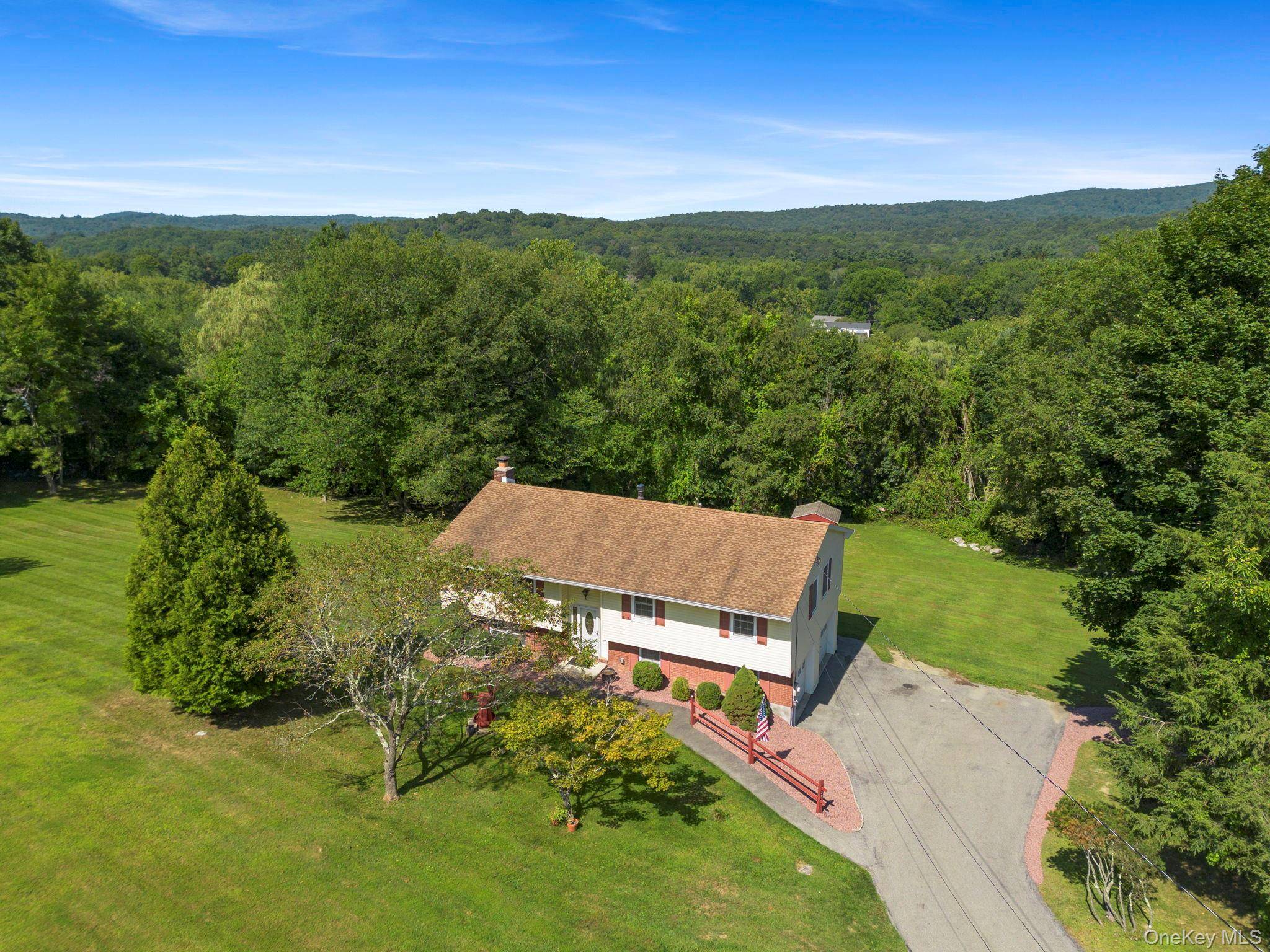 Nestled on an acre of green landscaped property sits a charming, spacious raised ranch.
