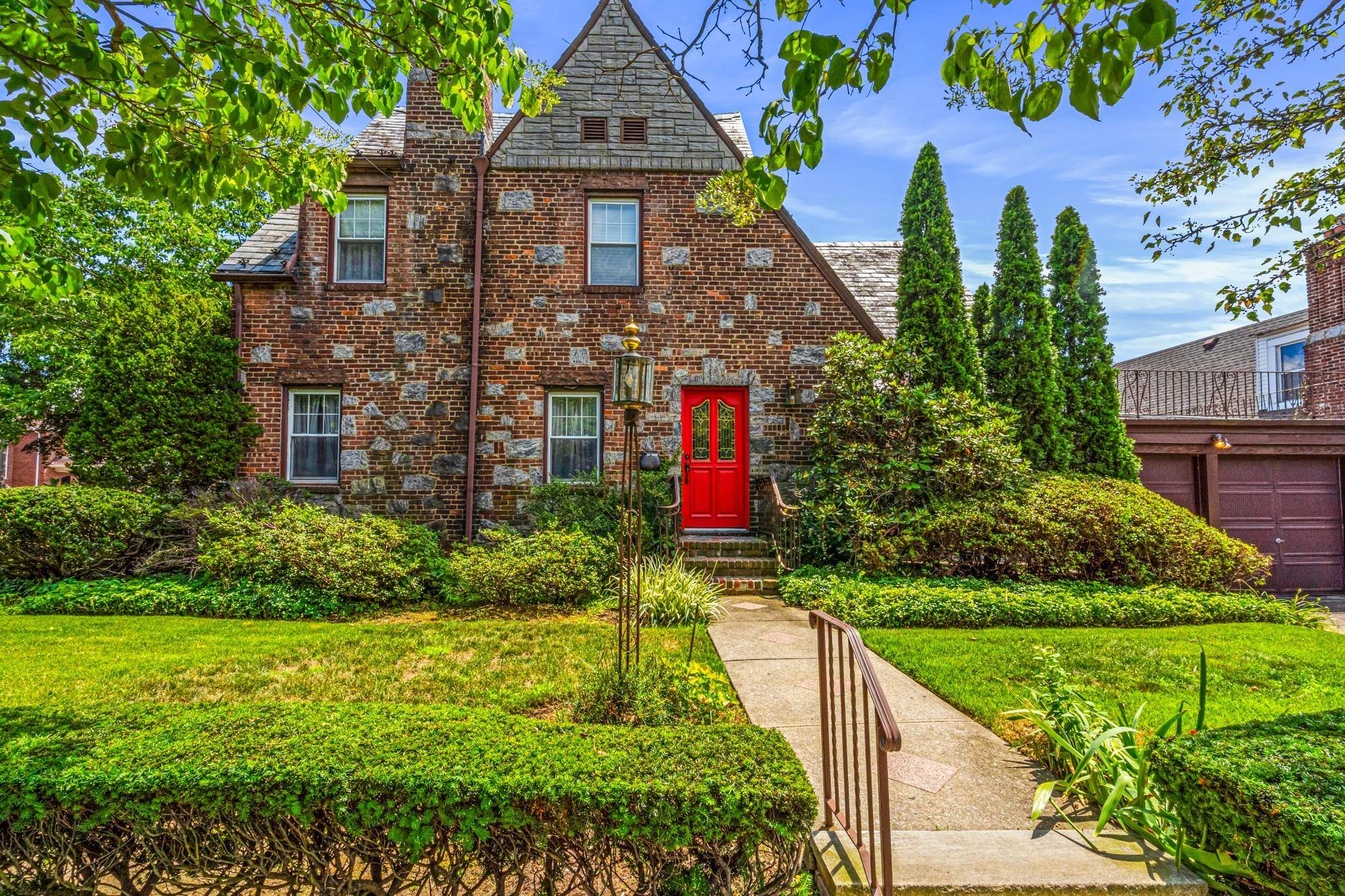 This stately brick and stone Tudor sits on a lovely 60 100 lot on a peaceful, tree lined street in Bayside.