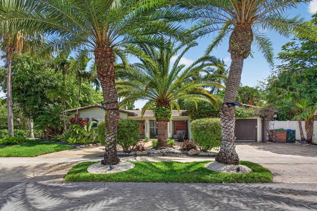 Set on a lushly landscaped prominent corner on gated Jenada Isle, this 4 bed 3 bath den residence was rebuilt with intention and smart home features.