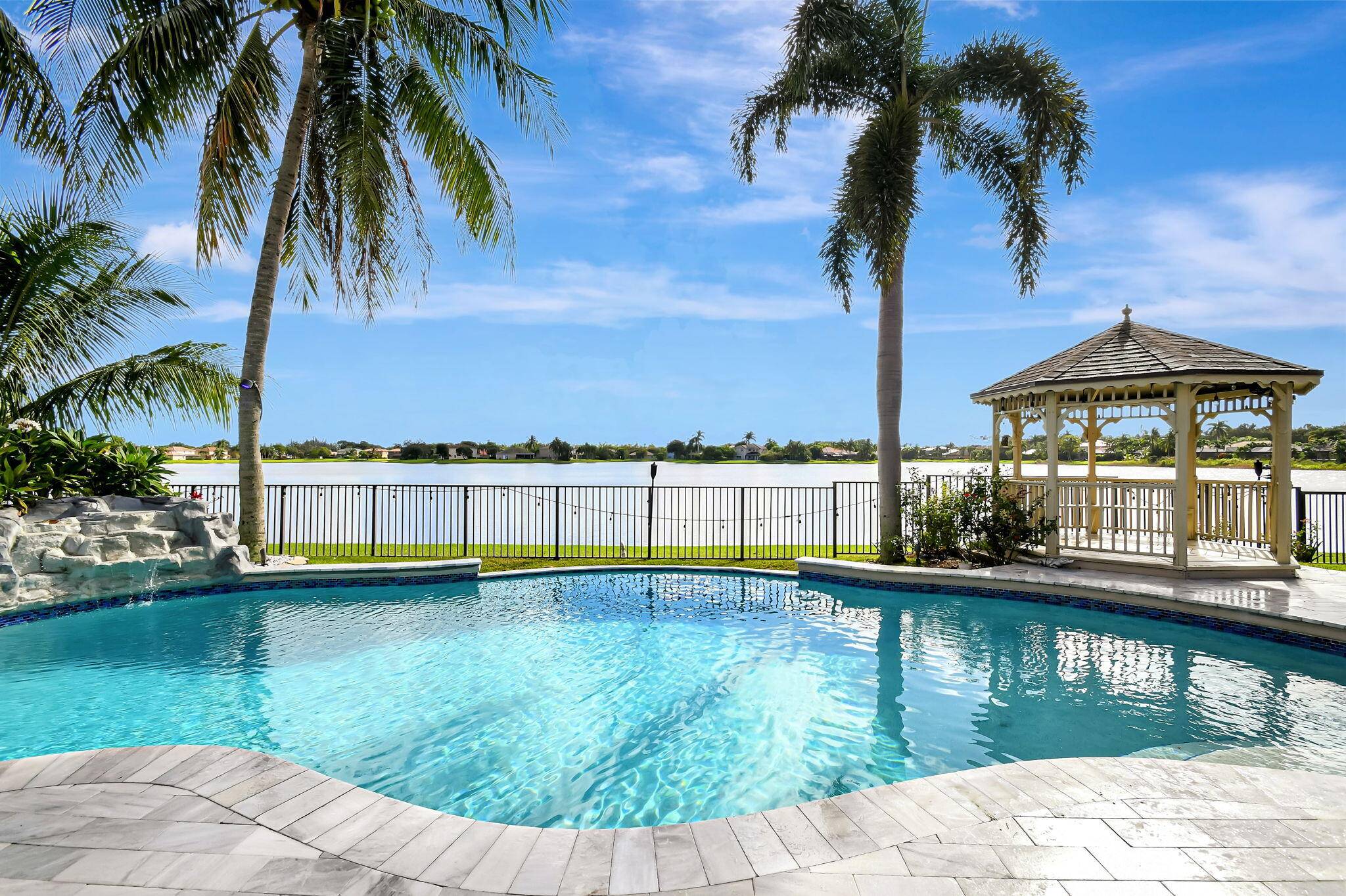 Fabulous renovated former model home 4 3 3 on an enormous lake with a heated pool and fenced yard.