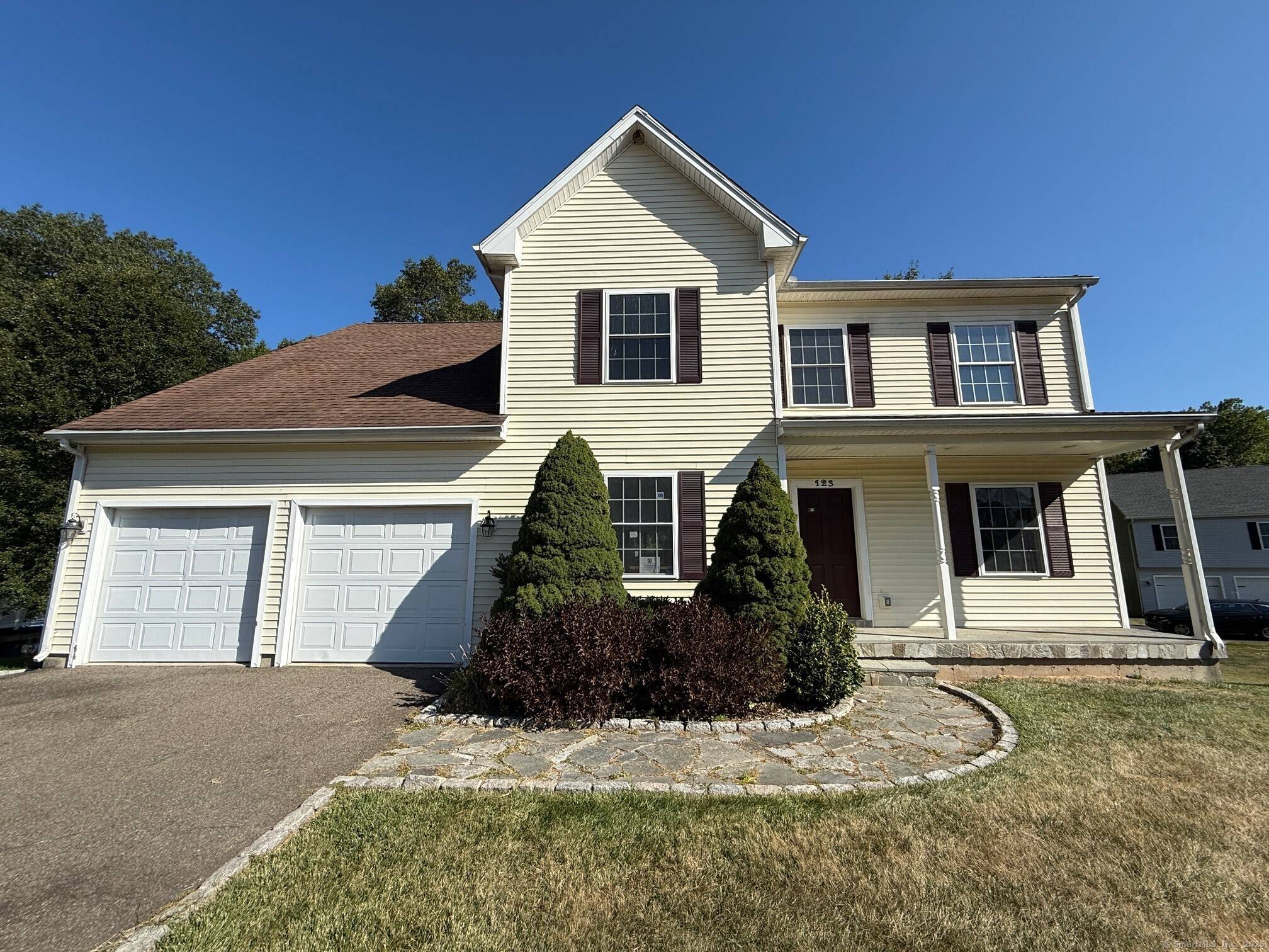 Vinyl sided Colonial with attached 2 car garage.