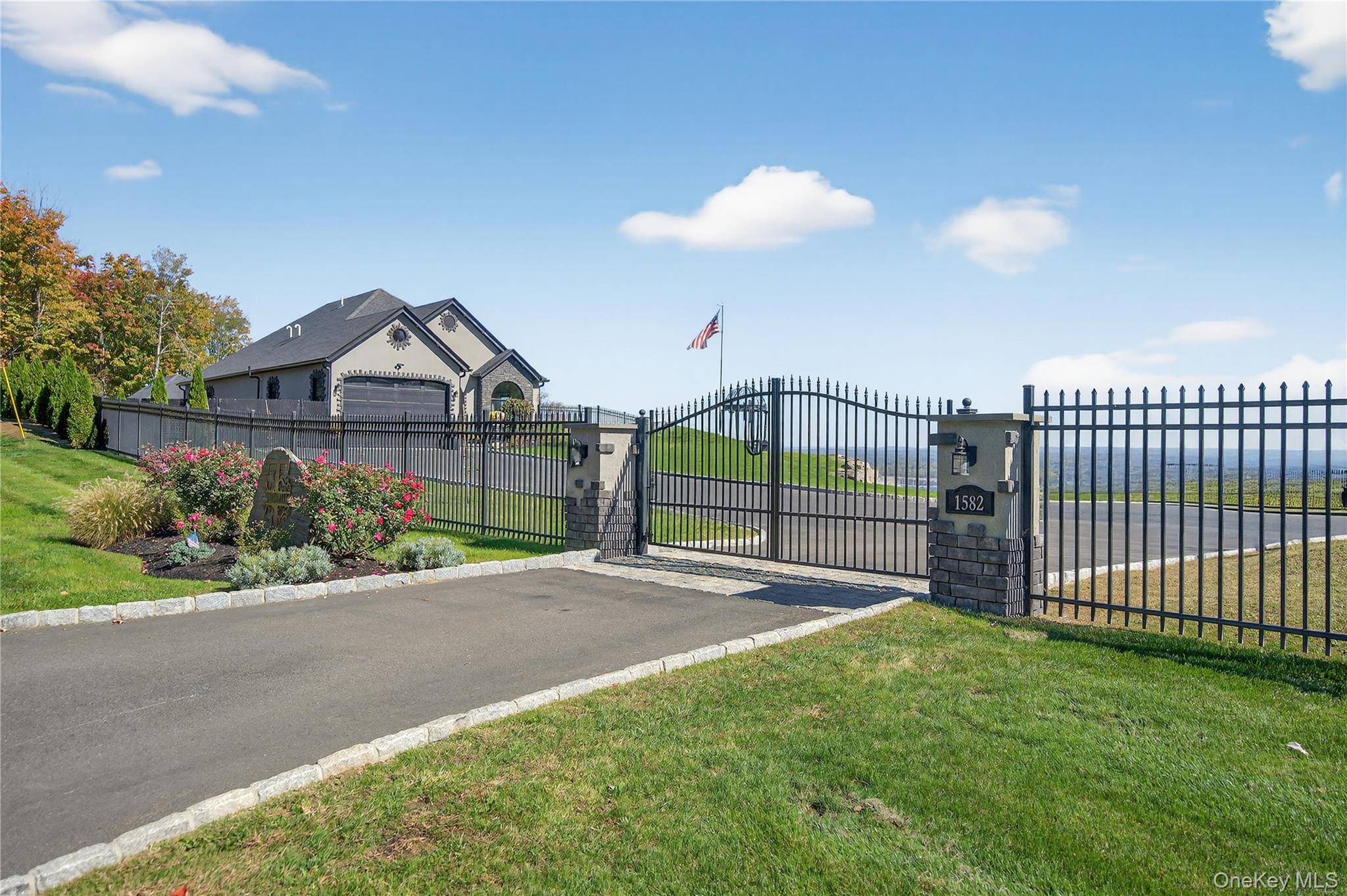 Perched on a hilltop with sweeping views of the Hudson River, this custom designed and built single level residence captures the essence of modern luxury living.