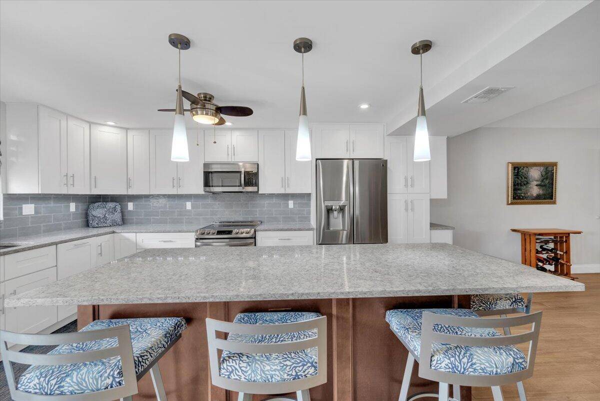 Welcome to this beautifully renovated 3 bedroom, 3 bathroom garden condo on the first floor of Ocean Parks, where modern elegance meets comfort.